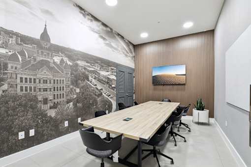 A conference room with a large printed image of a building on the wall.