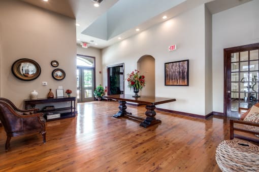 a living room with a hard wood floor and a table