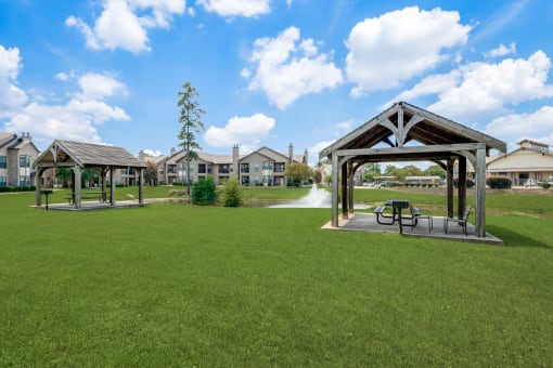 a park with a fountain and benches in the grass