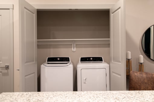 two washers and dryers in a laundry room