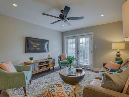 a living room with furniture and a ceiling fan