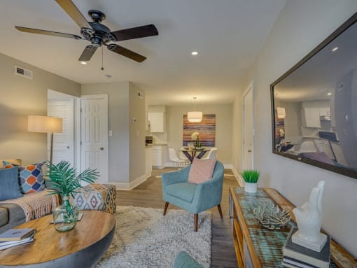 a living room with a couch and a ceiling fan