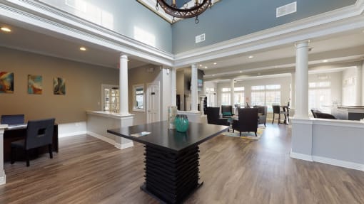 a dining room with a table and chairs in a large room