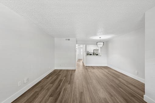 A room with wooden floors and white walls.
