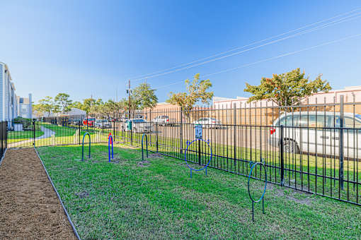 A playground with a swing set and a blue slide.