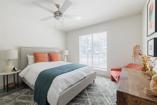 a bedroom with a bed and a ceiling fan