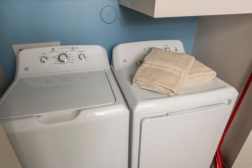 Two white washing machines at Woodbridge Villas Apartments, Sachse, Texas