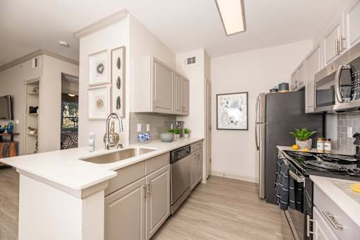 Kitchen with stainless steel appliances at Woodbridge Villas Apartments, Sachse, TX, 75048
