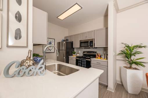 Kitchen with white countertops at Woodbridge Villas Apartments, Sachse, TX