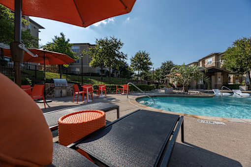 Pool area with a sun lounger at Woodbridge Villas Apartments, Texas