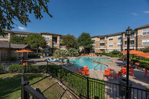 Swimming pool area at Woodbridge Villas Apartments, Sachse, TX