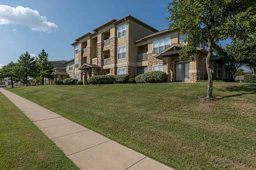 Buildings with a sidewalk at Woodbridge Villas Apartments, Texas, 75048
