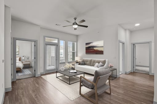a living room with a couch and a ceiling fan