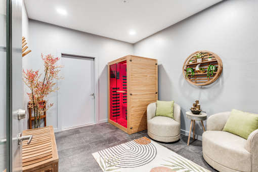 A room with a red door and a wooden cabinet.