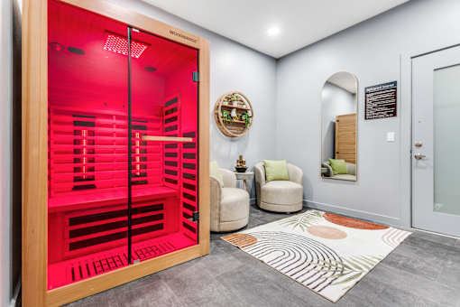 A red room with a chair and a wicker basket on the wall.