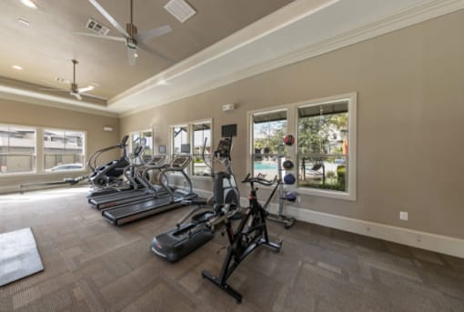 A spacious gym with treadmills, elliptical machines, and other exercise equipment.