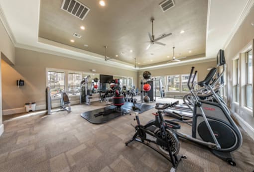 A spacious home gym with a variety of exercise equipment.