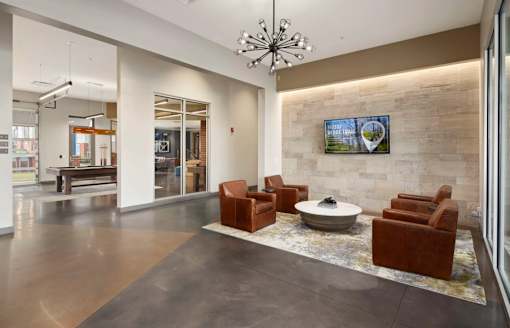 A modern living room with a stone wall and a flat screen TV.