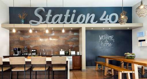A restaurant named Station 40 has a welcoming interior with wooden furniture and a chalkboard wall.