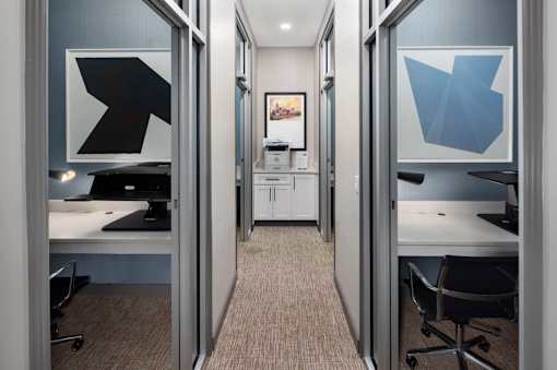 A hallway with two doors on either side leading to two different rooms.