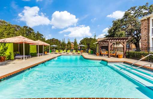 A large swimming pool with a blue tiled edge and a white tiled edge.