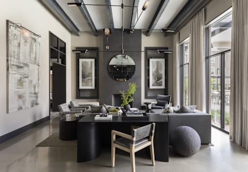 A modern living room with a black and white color scheme.