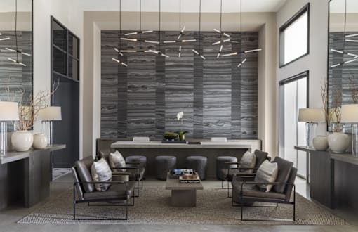A modern living room with a large sectional sofa and a coffee table.