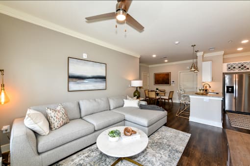 A modern living room with a grey sofa and a coffee table.
