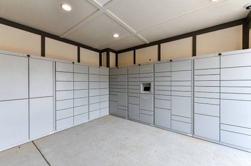 A room with a white wall and a grey door.