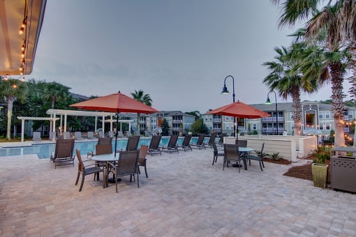 A patio with chairs and umbrellas is set up for dining.