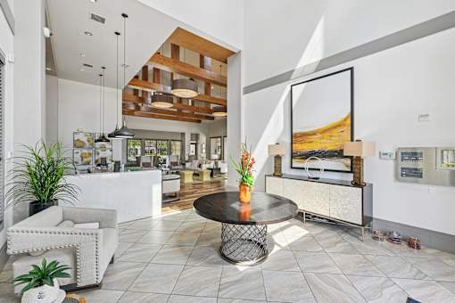 A modern living room with a white sofa and a coffee table.