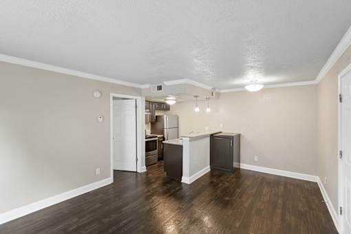 A room with a white ceiling and a wooden floor.