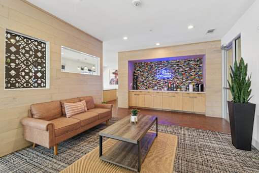 A living room with a brown couch and a coffee table.