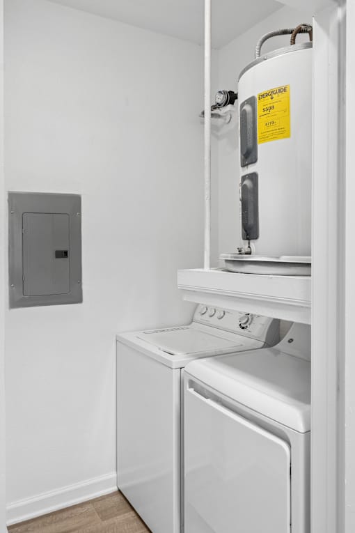 A white dishwasher and oven in a small kitchen.