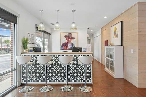 A reception area with a black and white patterned bar.