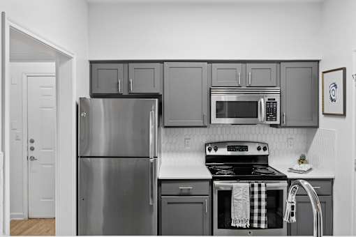 A kitchen with a stove and oven with a towel on it.