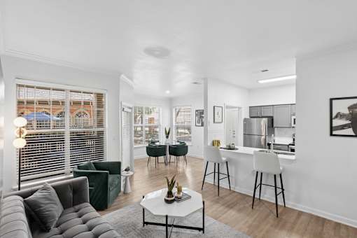 A modern living room with a grey sofa and a white coffee table.