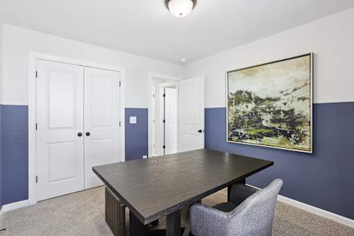 A dining room with a table and chairs.