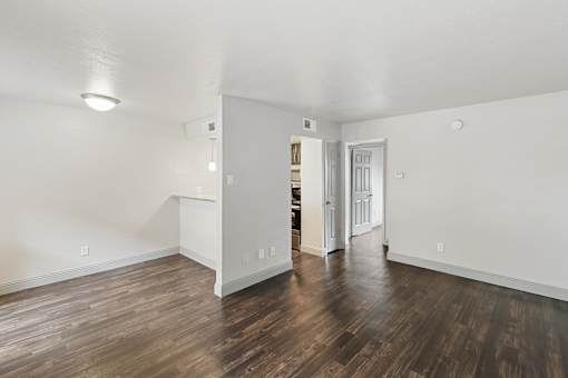 A room with wooden floors and white walls.