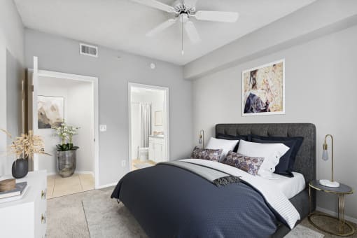 a bedroom with a bed and a ceiling fan