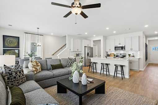 A modern living room with a grey sofa and a black coffee table.