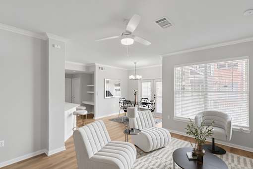 A living room with a white couch and a ceiling fan.