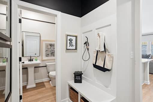 A bathroom with a toilet, sink, and a towel hanging on the wall.