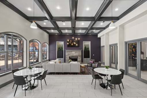 A modern dining room with a white table and chairs.