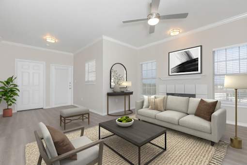A living room with a white couch, a coffee table, and a potted plant.