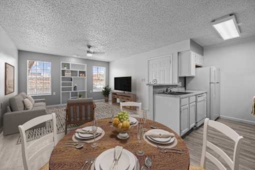 A dining room with a table set for a meal.
