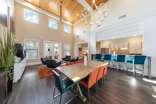A modern dining room with a wooden table and chairs.