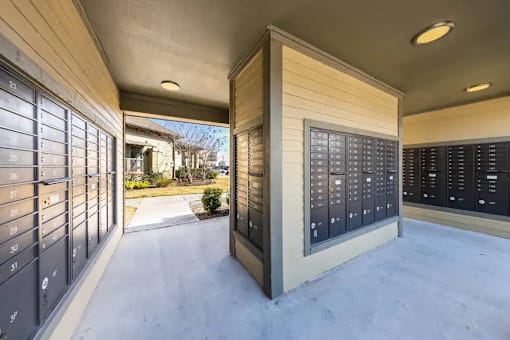 A long hallway with mailboxes on both sides.