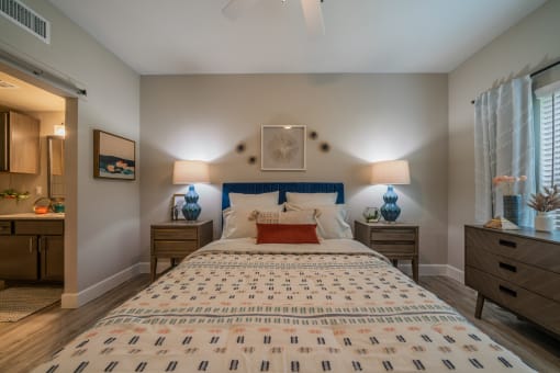 a bedroom with a bed and two nightstands