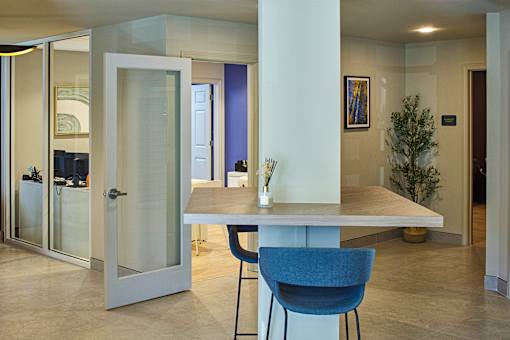A modern dining room with a table and chairs.